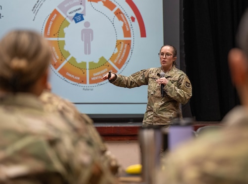 U.S. Air Force Capt. Amy Milho, Altus Operational Medical Readiness Squadron, clinical psychologist, speaks at a Mental Health Symposium at Altus Air Force Base, Oklahoma, March 17, 2026. The symposium featured briefings in three key areas: mental health services, the Alcohol and Drug Abuse Prevention and Treatment Program, and the Family Advocacy Program. (U.S. Air Force photo by Airman 1st Class Emma Wright)