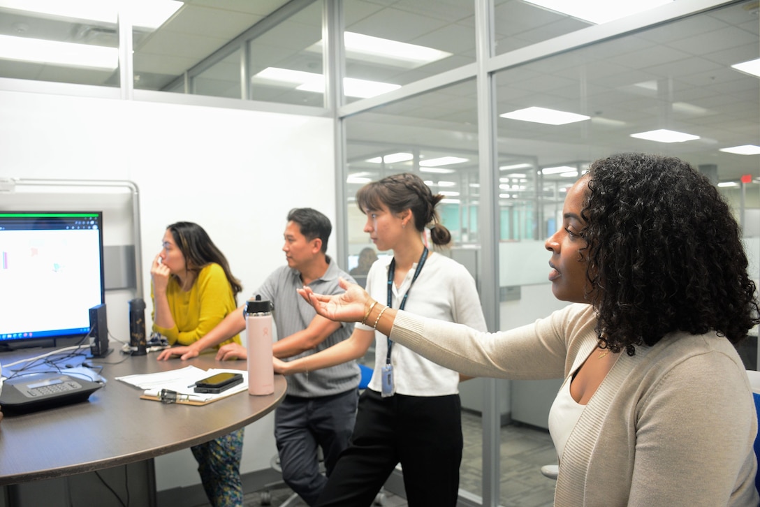 A person has a discussion with team members.