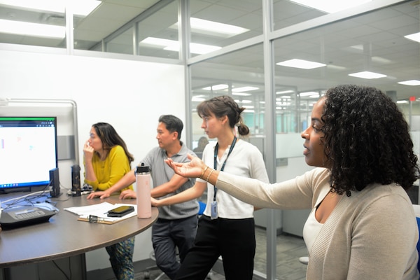 A person has a discussion with team members.