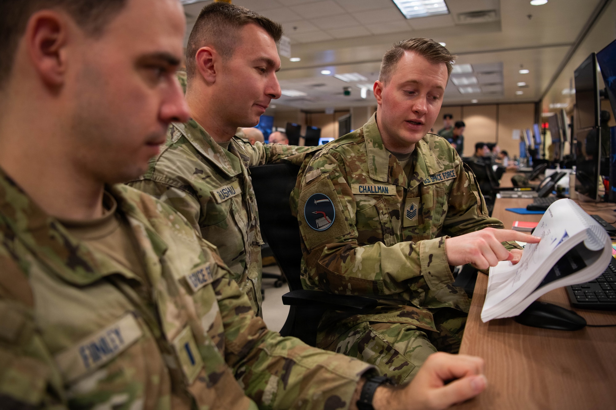 U.S. Space Force Tech. Sgt. James Challman, Space Training and Readiness Command’s non-commissioned officer in charge of the Cadet Space Operations Squadron in the Department of Astronautics, U.S. Air Force Academy, discusses exercise control plans during exercise Freedom Shield 26 at Osan Air Base, Republic of Korea, March 12, 2026. Challman served as an exercise control specialist during FS26, directing scenarios and adjudicating the effectiveness of simulated actions by exercise participants. (U.S. Space Force photo by 2nd Lt. Andrew Taller