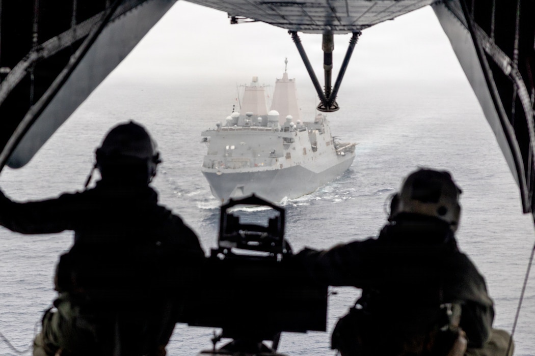 U.S. Marines, with Marine Medium Tiltrotor Squadron (VMM) 163 (Reinforced), 11th Marine Expeditionary Unit (MEU), observe San Antonio-class amphibious transport dock ship USS Portland (LPD 27) from a CH-53E Super Stallion during a tactical recovery of aircraft and personnel rehearsal in the Pacific Ocean, March 22, 2026. The 11th MEU is currently underway aboard the Boxer Amphibious Ready Group in the U.S. 3rd Fleet area of operations demonstrating the United States’ long-term commitment to a free and open Indo-Pacific. (U.S. Marine Corps photo by Cpl. Avery Wayland)