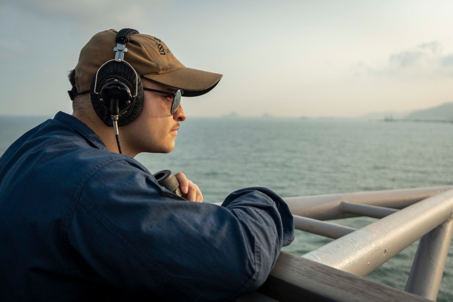 Quartermaster Seaman Adrian Garza stands look-out watch on the bridge aboard U.S. 7th Fleet flagship USS Blue Ridge (LCC 19) as the ship prepares to enter port in Laem Chabang, Thailand, March 26, 2026.