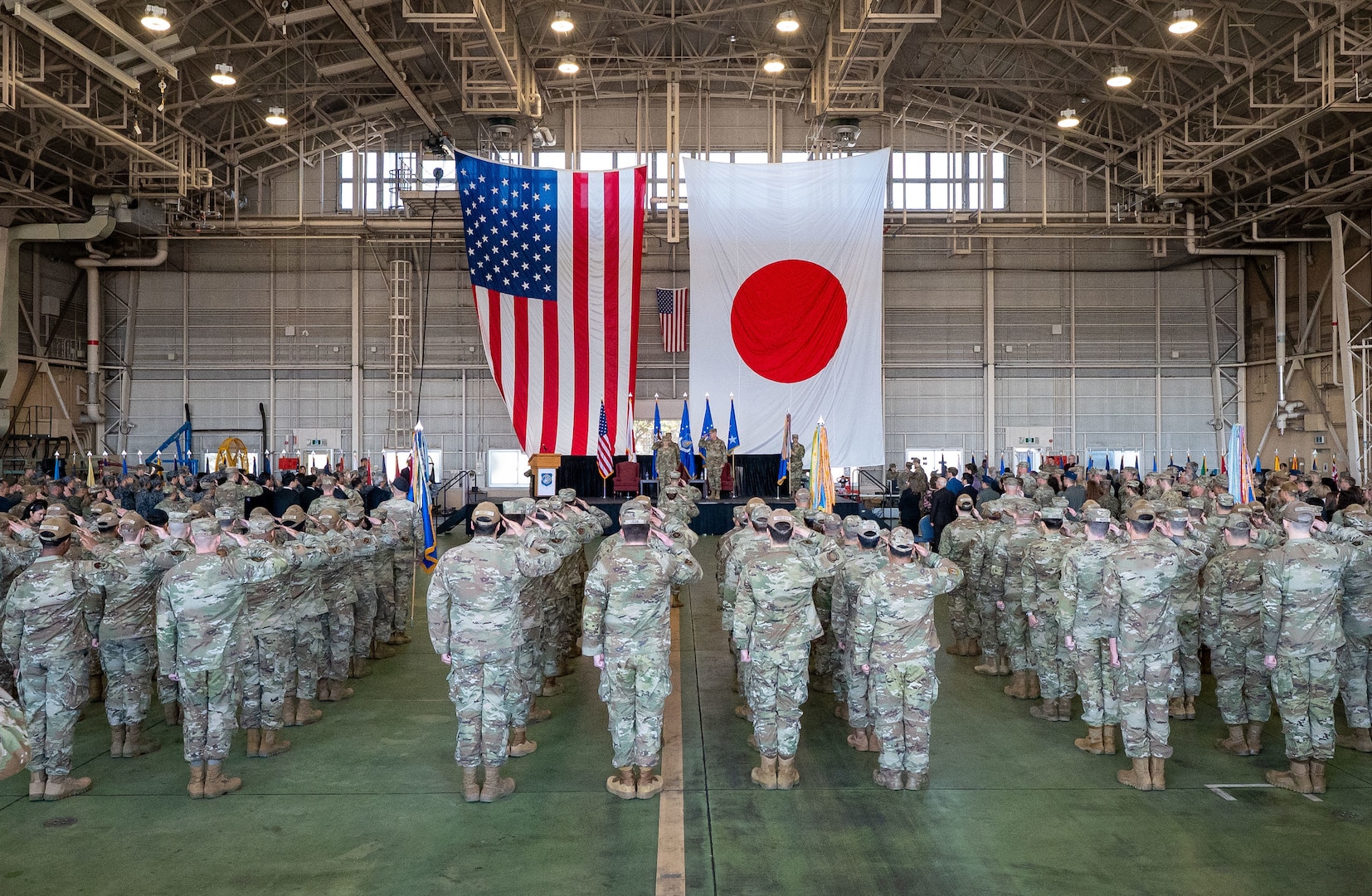 U.S. Forces Japan, 5th Air Force, and 374th Airlift Wing members assemble for a change of command ceremony at Yokota Air Base, Japan, March 24, 2026. USFJ and 5AF dual-commander position was separated, strengthening the command-and-control framework to enable seamless coordination of operations and capabilities, allowing for greater interoperability between U.S. and Japanese forces. (U.S. Air Force photo by Airman 1st Class Kayla Karelas)