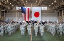 U.S. Forces Japan, 5th Air Force, and 374th Airlift Wing members assemble for a change of command ceremony at Yokota Air Base, Japan, March 24, 2026. USFJ and 5AF dual-commander position was separated, strengthening the command-and-control framework to enable seamless coordination of operations and capabilities, allowing for greater interoperability between U.S. and Japanese forces. (U.S. Air Force photo by Airman 1st Class Kayla Karelas)