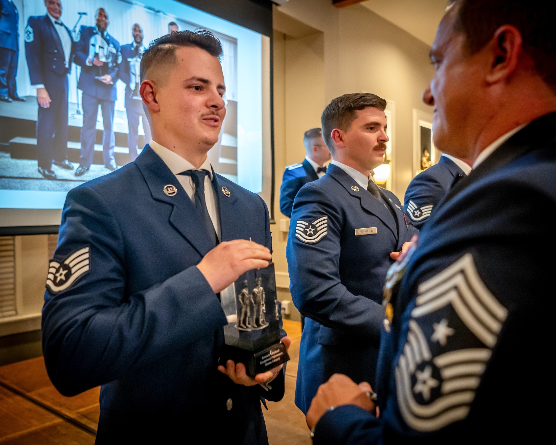 Senior Airman Ethan Greco, left, the Kentucky Air National Guard’s 2026 Airman of the Year, receives the Kentucky Enlisted Exceptional Performance Award from Chief Master Sgt. Blair Baerny, 123rd Airlift Wing command chief master sergeant, during the Airman’s Gala at Wildwood Country Club in Louisville, Ky., March 14, 2026. The Gala celebrated wing Airmen who displayed exceptional performance and community engagement in 2025. (U.S. Air National Guard photo by Master Sgt. Joshua Horton)