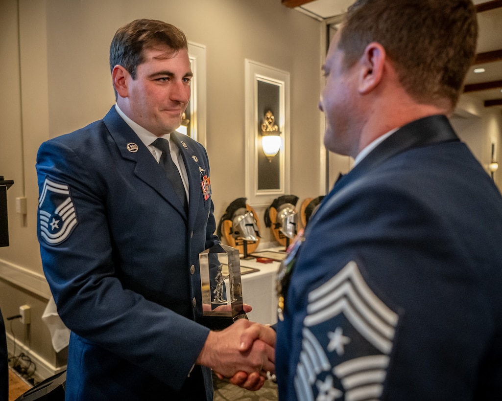 Senior Master Sgt. Dallas Stoll, left, the Kentucky Air National Guard’s 2026 Senior Non-Commissioned Officer of the Year, receives the Kentucky Enlisted Exceptional Performance Award from Chief Master Sgt. Blair Baerny, 123rd Airlift Wing command chief master sergeant, during the Airman’s Gala at Wildwood Country Club in Louisville, Ky., March 14, 2026. The Gala celebrated wing Airmen who displayed exceptional performance and community engagement in 2025. (U.S. Air National Guard photo by Master Sgt. Joshua Horton)