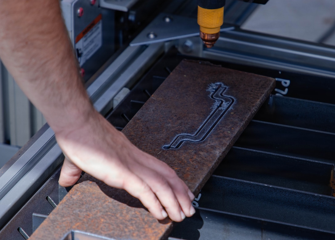Close up of hand touching printed metal