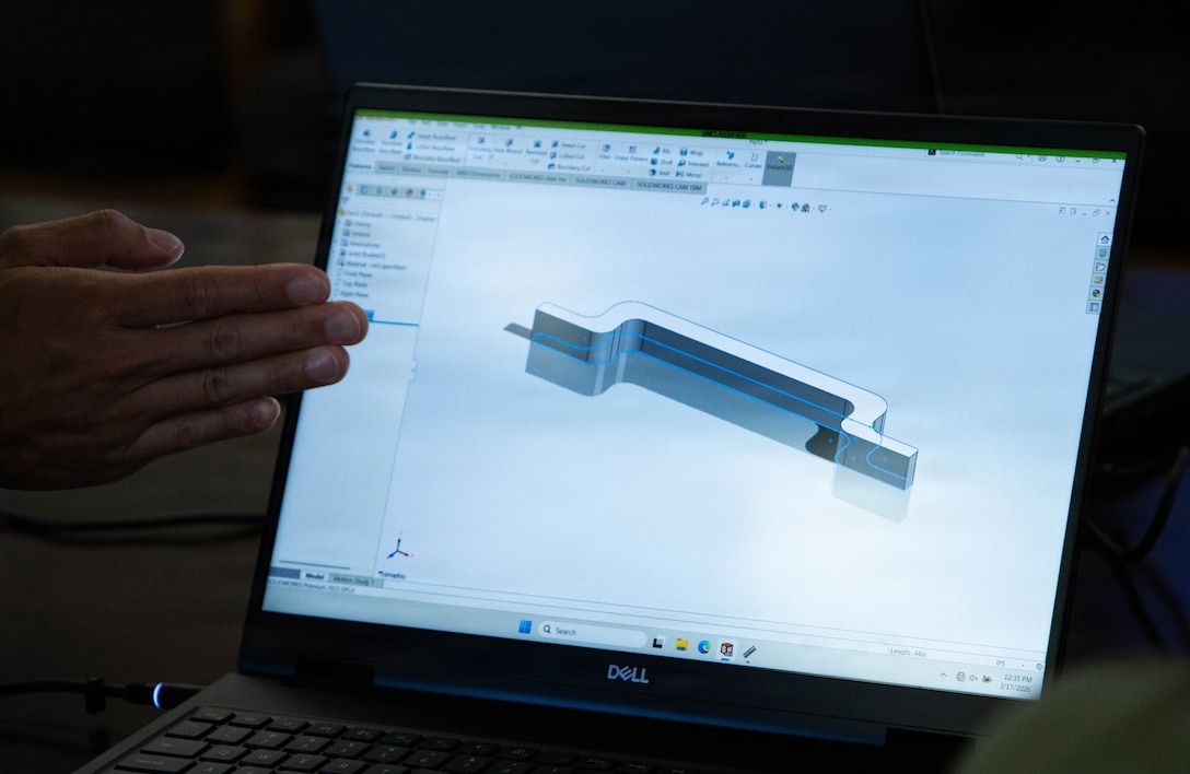 hand pointing at computer screen