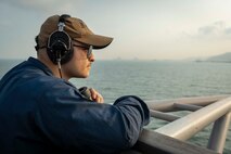 Quartermaster Seaman Adrian Garza stands look-out watch on the bridge aboard U.S. 7th Fleet flagship USS Blue Ridge (LCC 19) as the ship prepares to enter port in Laem Chabang, Thailand, March 26, 2026.