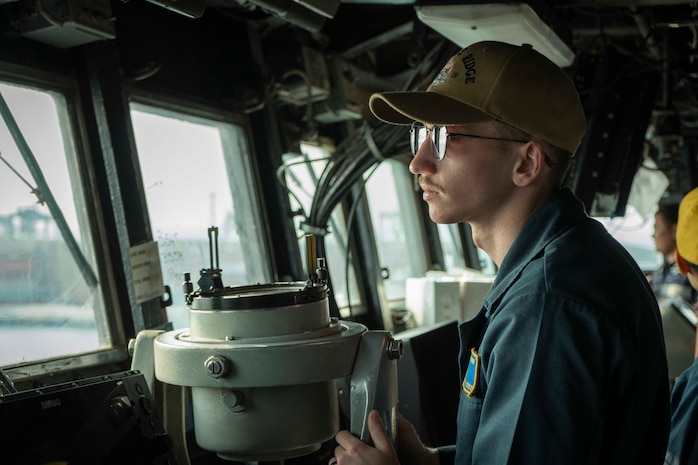 Ensign Chance Sylvester stands watch on the bridge aboard U.S. 7th Fleet flagship USS Blue Ridge (LCC 19) as the ship prepares to enter port in Laem Chabang, Thailand, March 26, 2026.