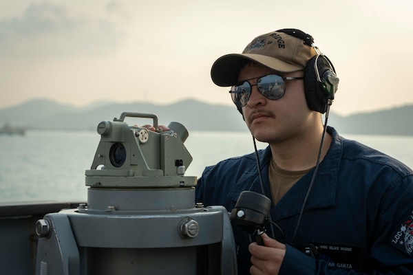 Quartermaster Seaman Adrian Garza stands look-out watch on the bridge aboard U.S. 7th Fleet flagship USS Blue Ridge (LCC 19) as the ship prepares to enter port in Laem Chabang, Thailand, March 26, 2026.