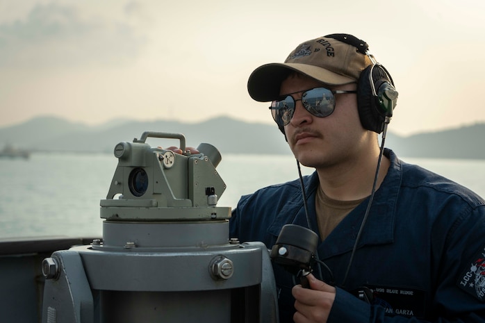 Quartermaster Seaman Adrian Garza stands look-out watch on the bridge aboard U.S. 7th Fleet flagship USS Blue Ridge (LCC 19) as the ship prepares to enter port in Laem Chabang, Thailand, March 26, 2026.