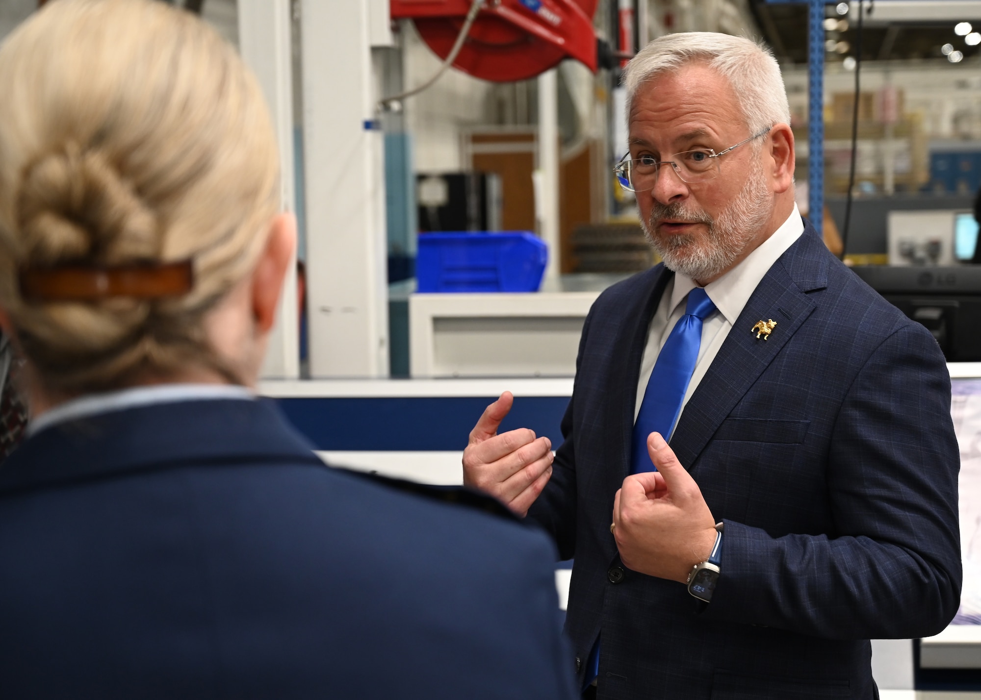 A civilian and military leader signing an agreement.