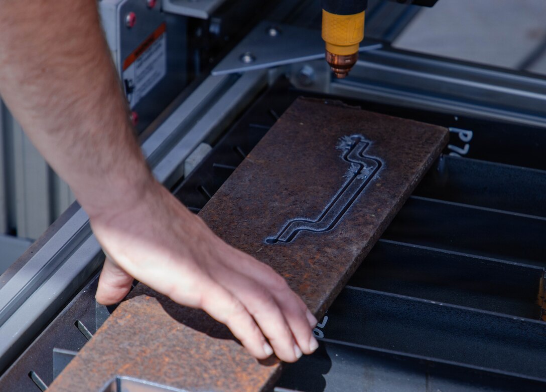 Close up of hand touching printed metal
