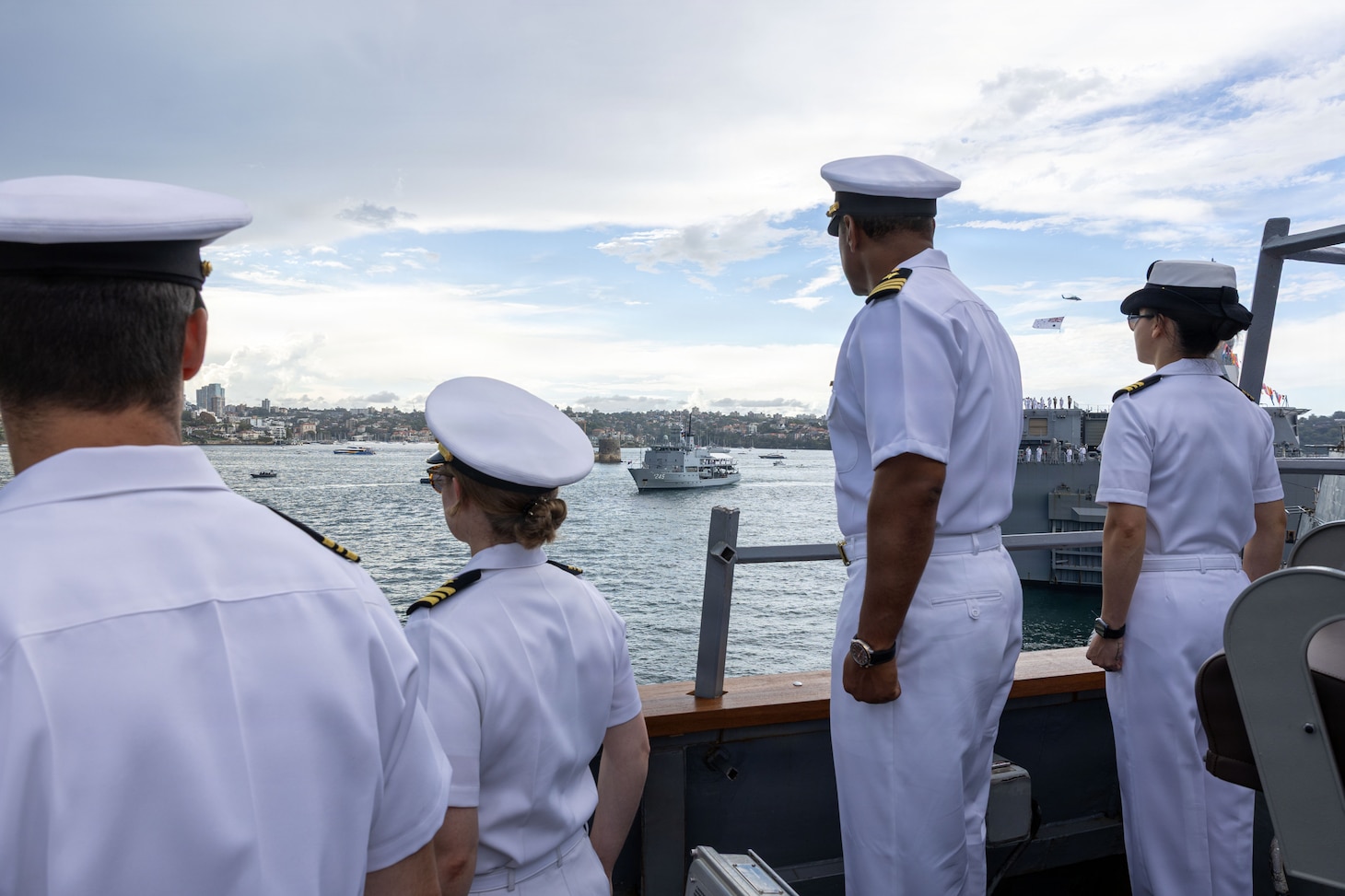 U.S. Navy Cmdr. Paul Richardson, center right, commanding officer of Arleigh Burke-class guided-missile destroyer USS Fitzgerald (DDG 62) observes the Leeuwin-class survey ship HMAS Leeuwin (A 245) during a fleet review as a part of Exercise Kakadu in Sydney, March 21, 2026.