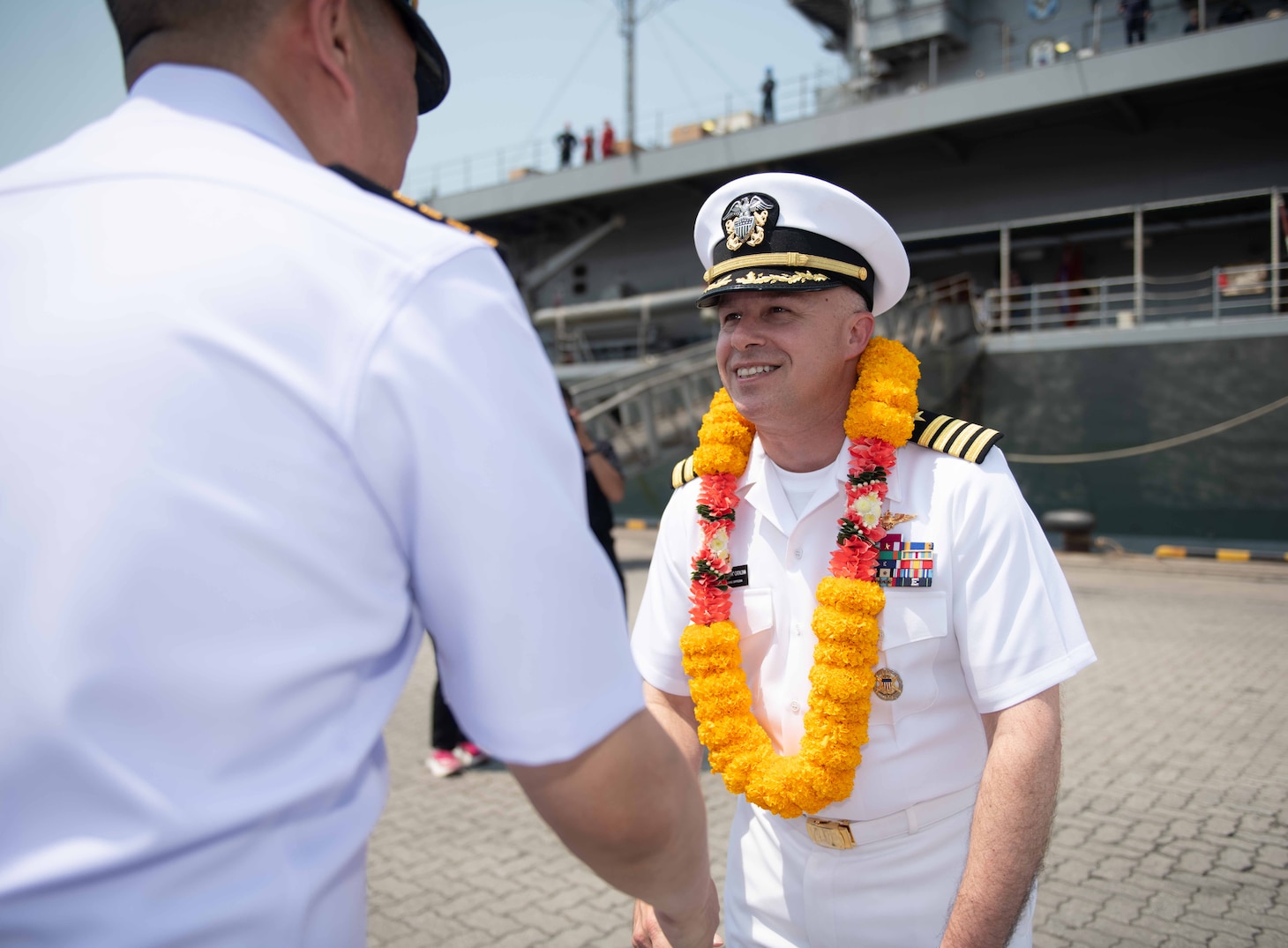 U.S. Navy Capt. Louis F. Catalina, commanding officer, U.S. 7th Fleet flagship USS Blue Ridge (LCC 19), right, is greeted by Capt. Kittipan Chaisiridham, commanding officer, HTMS Similan (871), during an arrival ceremony in Laem Chabang, Thailand, March 26, 2026.