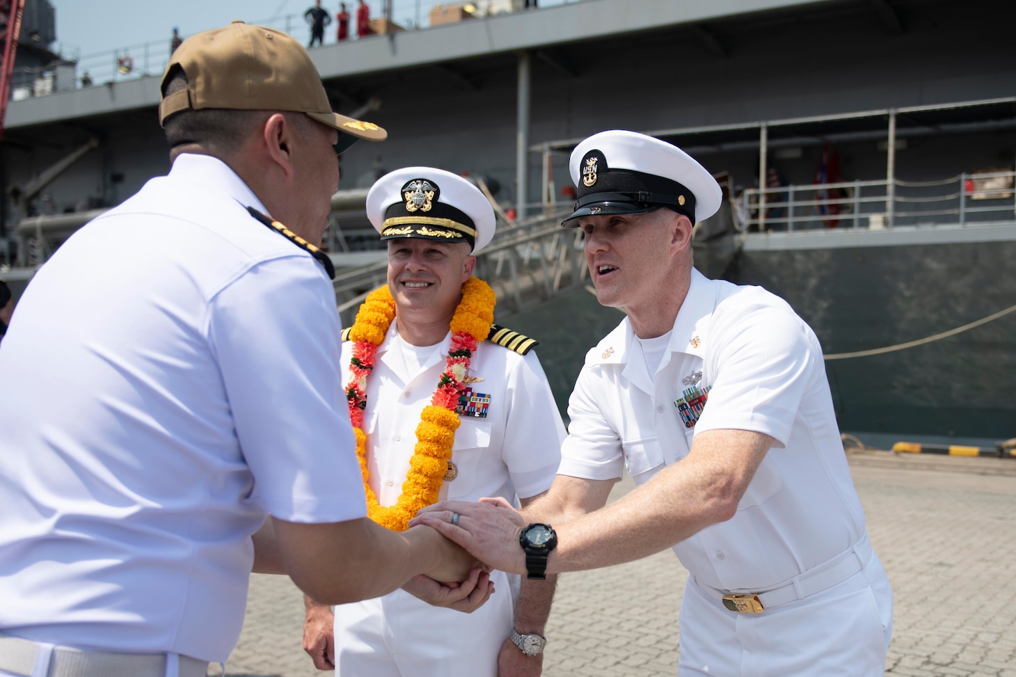 Master Chief Information Systems Technician Jeremy A. Morris, right, and U.S. Navy Capt. Louis F. Catalina, commanding officer of U.S. 7th Fleet flagship USS Blue Ridge (LCC 19), center, greet Capt. Kittipan Chaisiridham, commanding officer, HTMS Similan (871), left, during an arrival ceremony in Laem Chabang, Thailand, March 26, 2026.