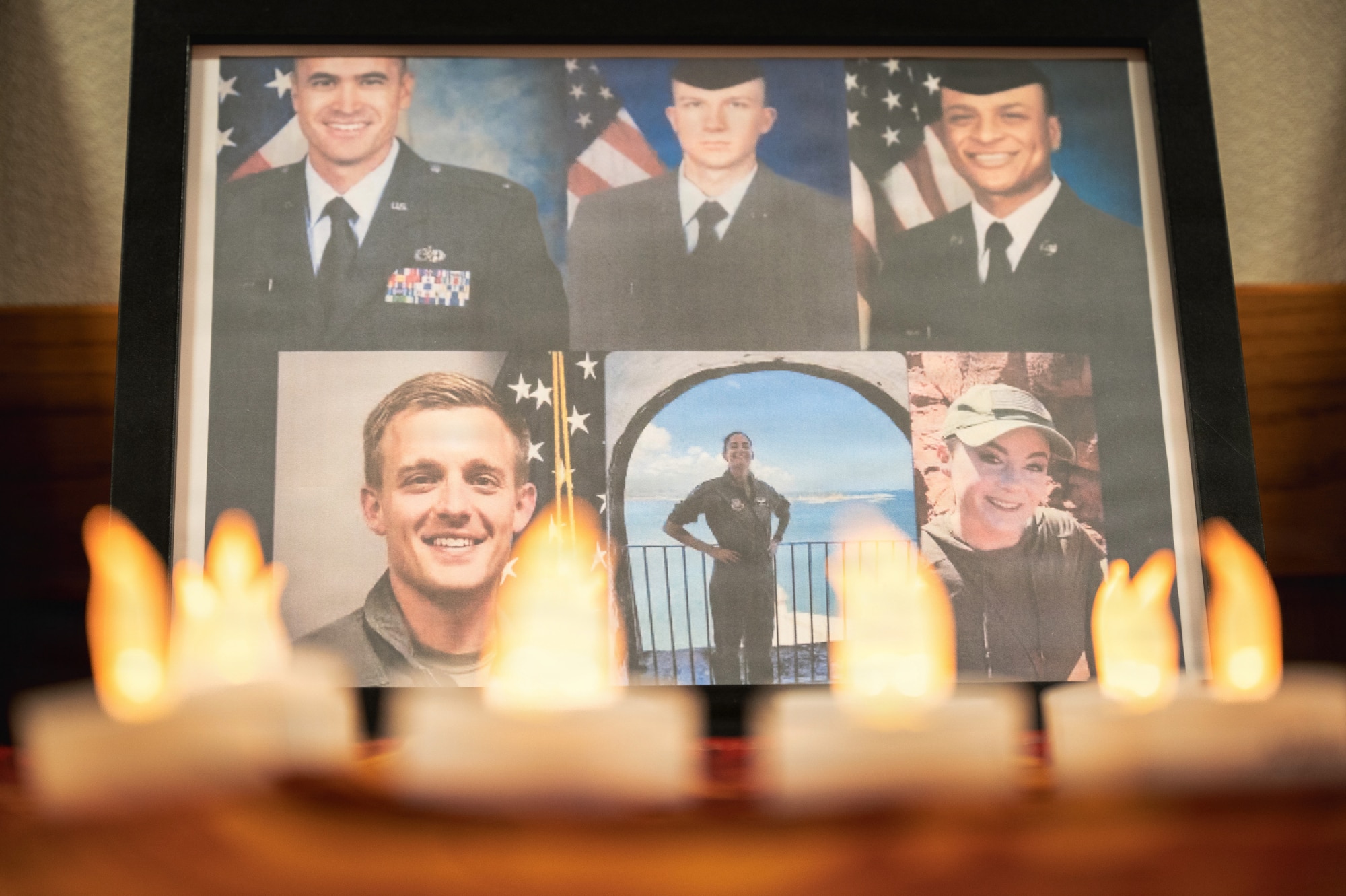 A display featuring the six Airmen who lost their lives in a KC-135 Stratotanker crash is shown during a vigil at Kadena Air Base, Japan, March 20, 2026.