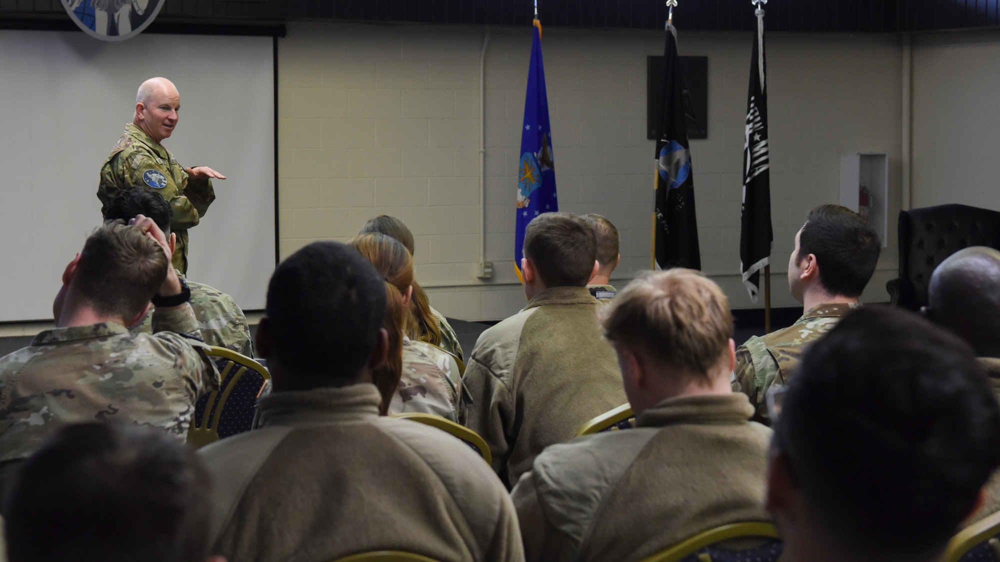 Photo of man talking to a group of people.