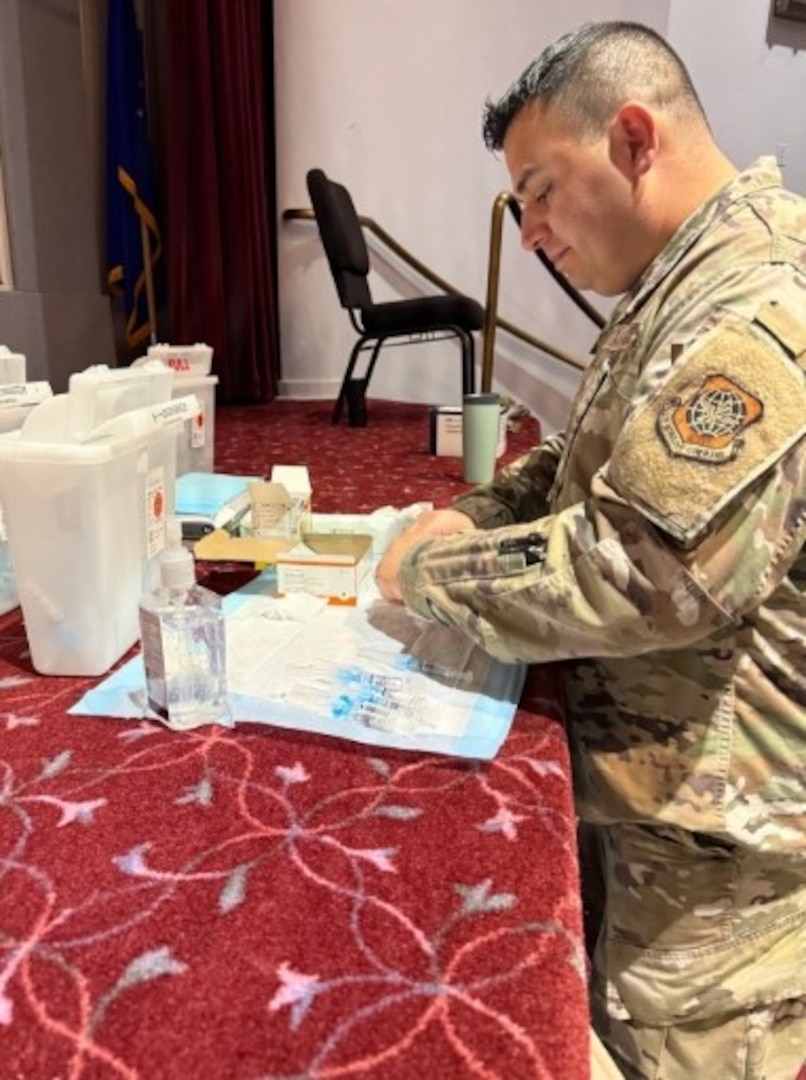 Ensuring the health and readiness of our service members, U.S. Air Force Tech. Sgt. Jonathan Perez, a military nurse with the 62nd Medical Squadron, provides critical support at the annual flu line at the McChord Theater.