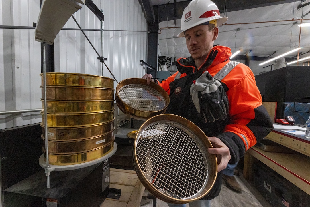A man stands in a concrete testing laboratory.