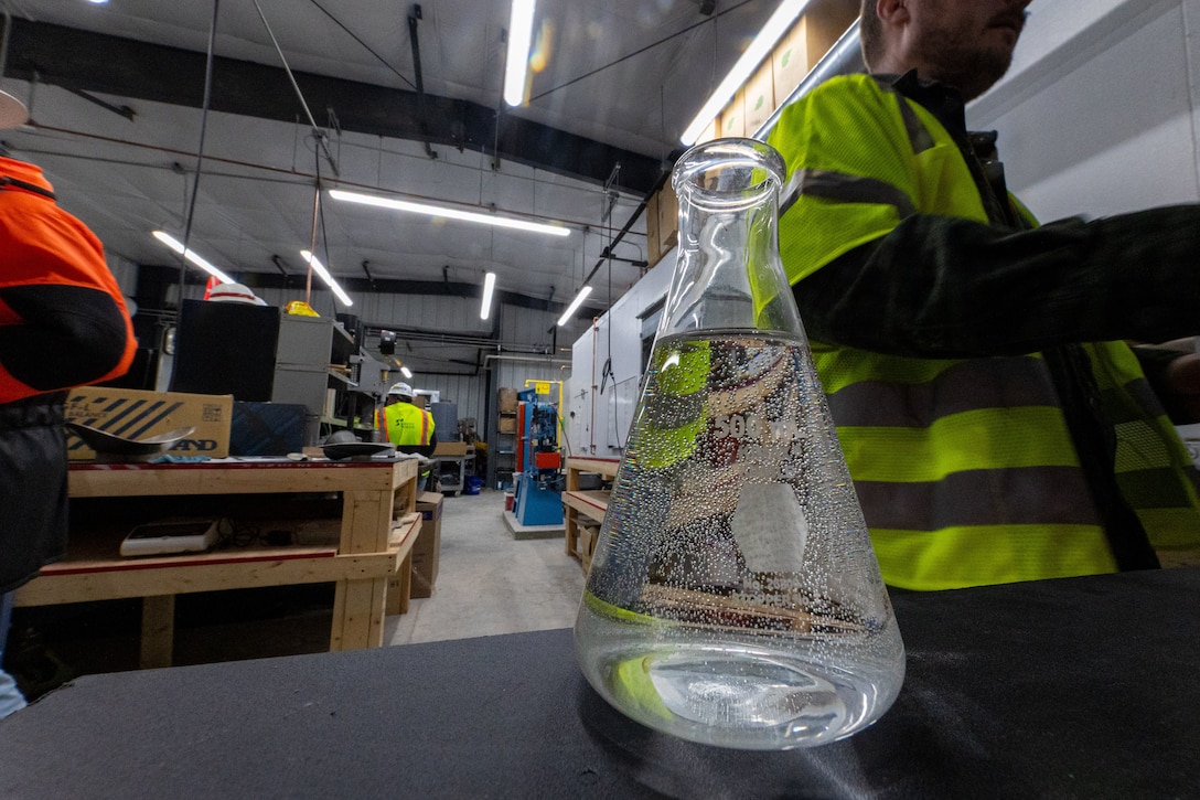 A filled beaker inside a laboratory.