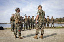 U.S. Marine Corps 1st Lt. Sylvester Guillermo, left, officer in charge of the Maritime Distribution Platoon, 2nd Distribution Support Battalion, introduces the Marines and Sailors of Maritime Distribution Platoon to Maj. Gen. Andrew Niebel, Assistant Deputy Commandant of Installations and Logistics, at Marine Corps Base Camp Lejeune, North Carolina, March 18, 2026. Niebel and Brig. Gen. Maura M. Hennigan received a demonstration and information for the autonomous low-profile vessel and other innovation efforts being used within 2nd MLG. Niebel is a native of Maryland. (U.S. Marine Corps photo by Staff Sgt. Makayla Elizalde)