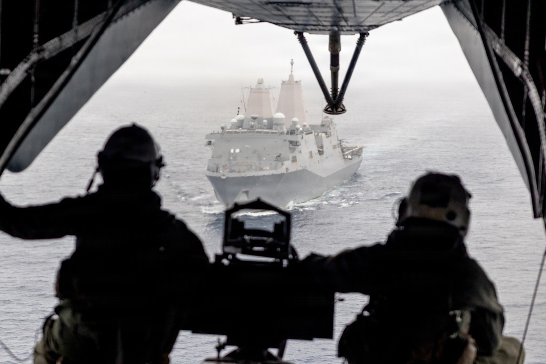 U.S. Marines with Marine Medium Tiltrotor Squadron (VMM) 163 (Reinforced), 11th Marine Expeditionary Unit, observe San Antonio-class amphibious transport dock ship USS Portland (LPD 27) from a CH-53E Super Stallion during a tactical recovery of aircraft and personnel rehearsal in the Pacific Ocean, Mar 22, 2026. The 11th MEU is currently underway aboard the Boxer Amphibious Ready Group in the U.S. 3rd Fleet area of operations demonstrating the United States’ long-term commitment to a free and open Indo-Pacific. (U.S. Marine Corps photo by Cpl. Avery Wayland)