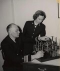 Cmdr. Howard Aiken and Lt. Grace Hopper working together, 1946. Their work on early computing systems helped lay the foundation for programming approaches that later enabled large organizations, including the Navy, to standardize software processes across multiple platforms. © Grace Murray Hopper Collection, Archives Center, National Museum of American History, Smithsonian Institution.