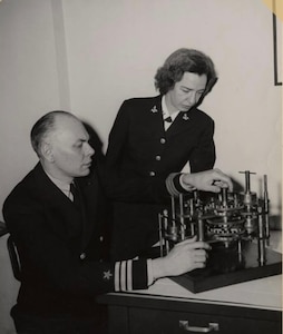 Cmdr. Howard Aiken and Lt. Grace Hopper working together, 1946. Their work on early computing systems helped lay the foundation for programming approaches that later enabled large organizations, including the Navy, to standardize software processes across multiple platforms. © Grace Murray Hopper Collection, Archives Center, National Museum of American History, Smithsonian Institution.