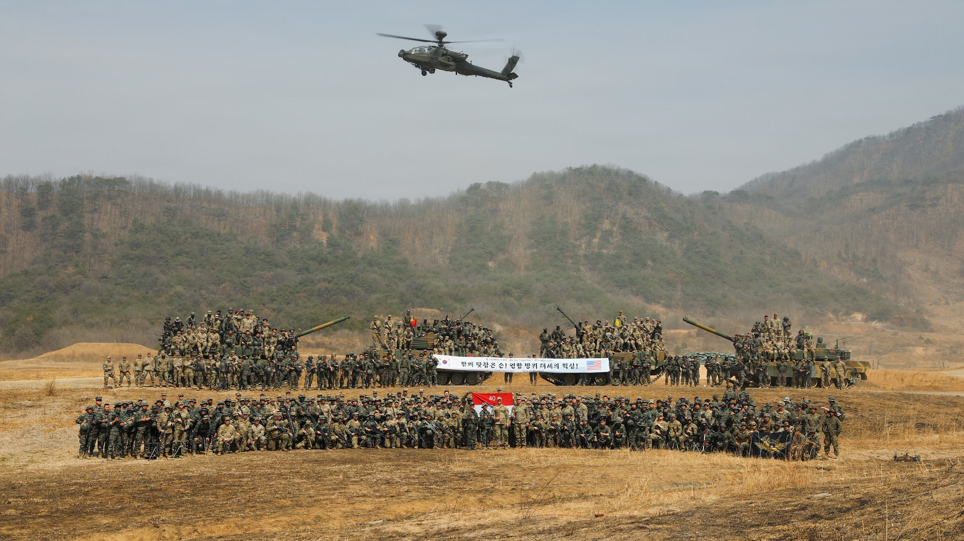 U.S. Army Soldiers assigned to the 11th Airborne Division and pilots assigned to the 2nd Combat Aviation Brigade, 2d Infantry Division/ROK-U.S. Combined Division; U.S. Marines assigned to the 9th Engineer Support Battalion, 3rd Marine Logistics Group, and Air Naval Gunfire Liaison Company; Republic of Korea Army Soldiers assigned to the 122nd Mechanized Battalion; and Republic of Korea Marines assigned to the 73rd Marine Battalion celebrate the completion of a combined arms live-fire exercise at Rodriguez Live Fire Complex, South Korea, March 24, 2026.