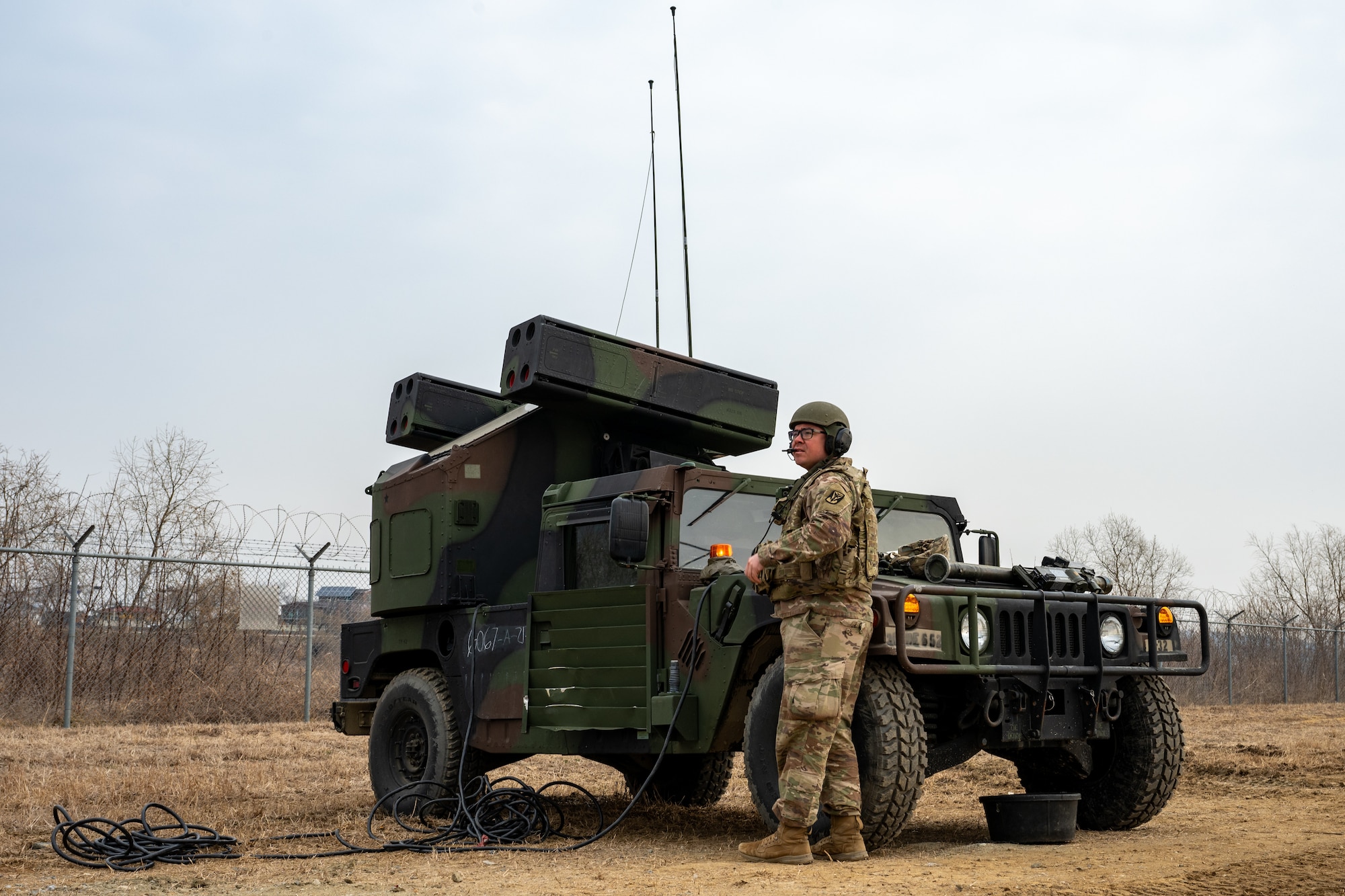 A Soldier scans the sky for a small, unmanned aerial system.