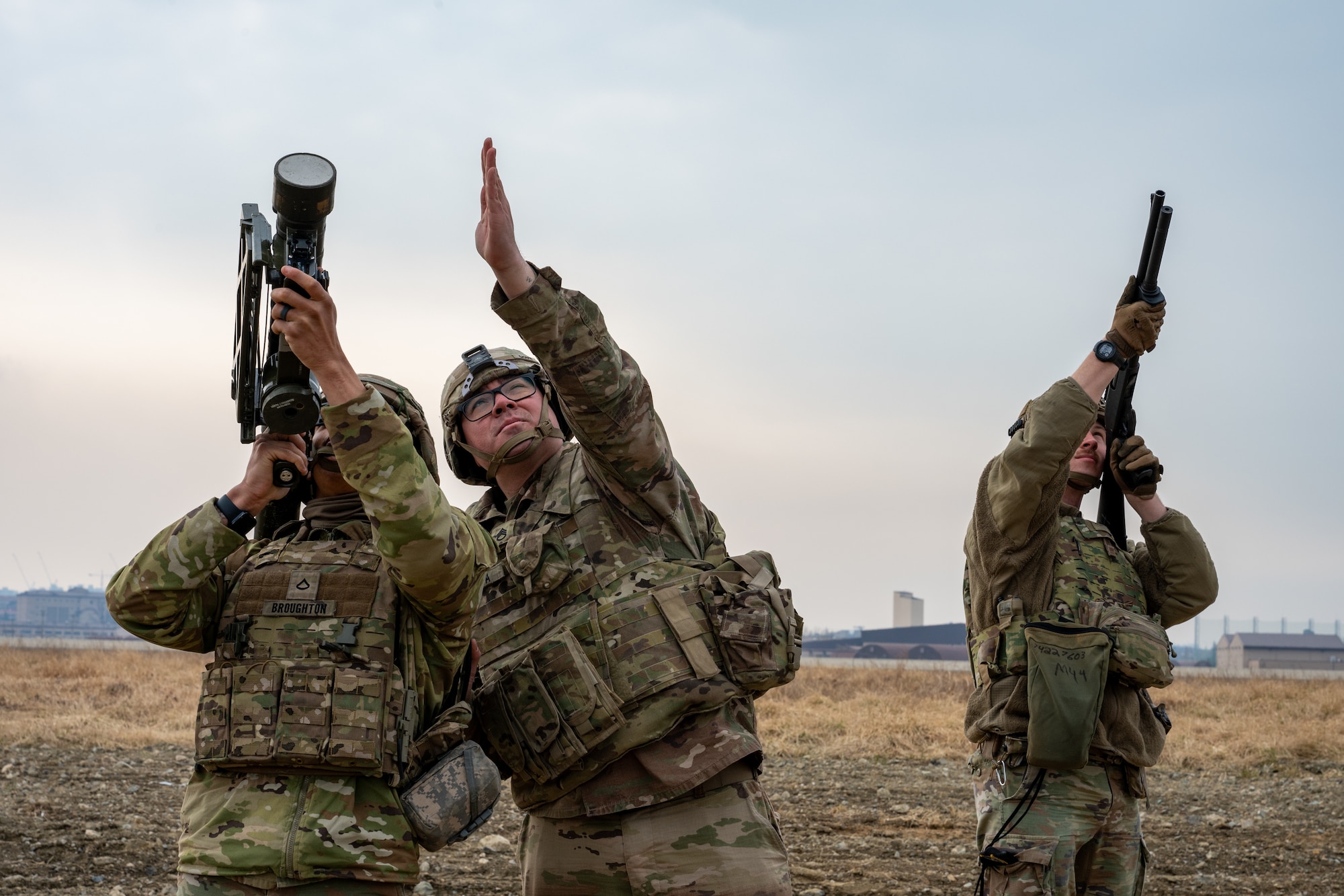 An Airman and Soldiers target a small, unmanned aerial system.