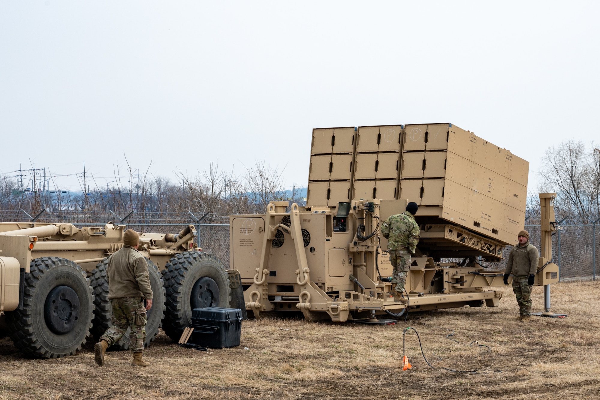 Soldiers inspect an air defense system.