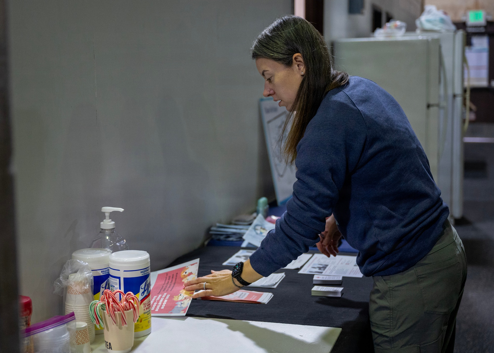 Jordan Jacobs, American Red Cross regional program manager and 51st Logistics Readiness Squadron key support liaison, cleans up the Red Cross table at Rush Park, Osan Air Base, Republic of Korea, March 18, 2026. Jacobs has dedicated her time at Osan to building connections, strengthening community and ensuring families know exactly where to turn when they need help. (U.S. Air Force photo by Staff Sgt. Sarah Williams)