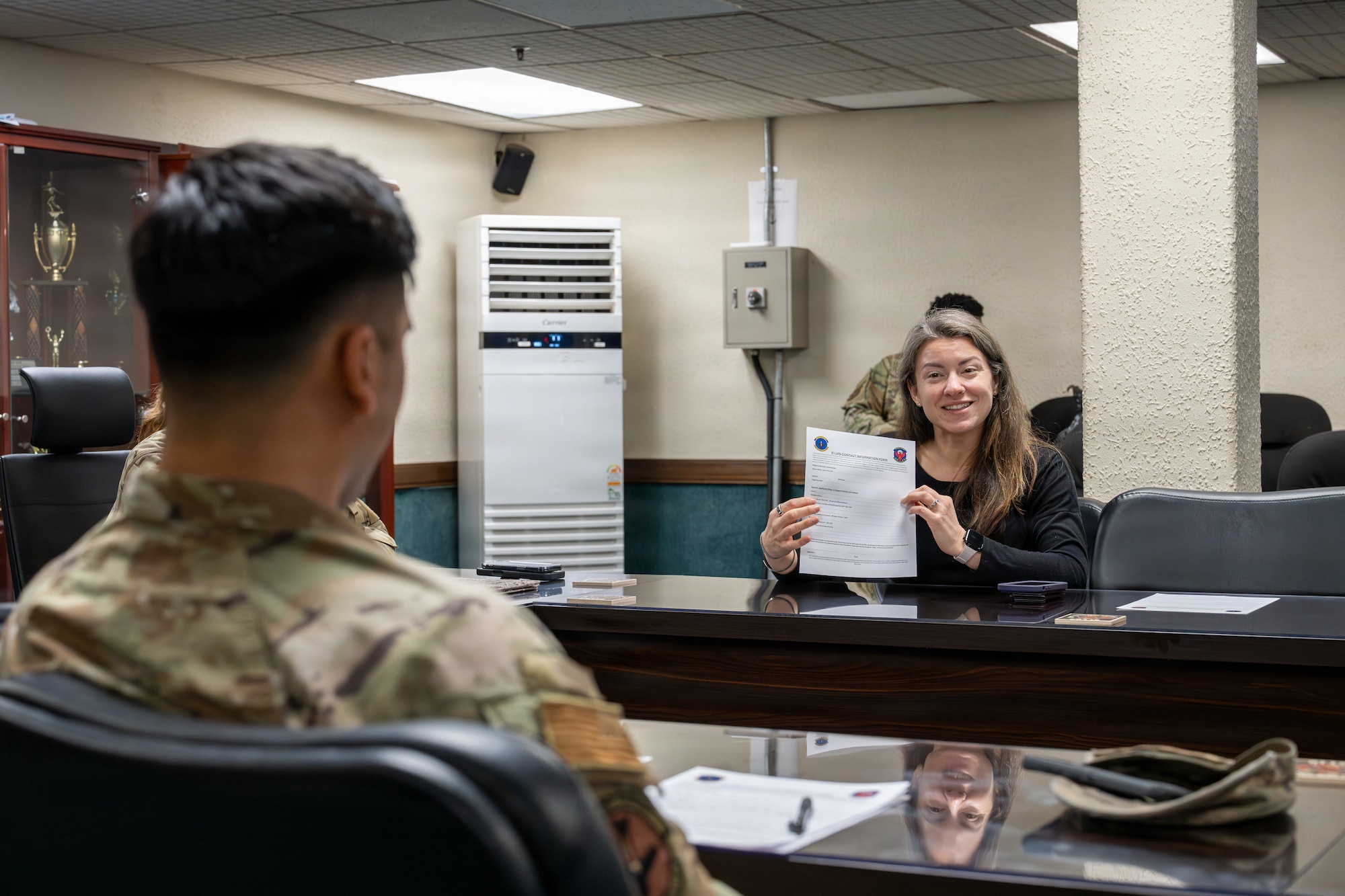Jordan Jacobs, American Red Cross regional program manager and 51st Logistics Readiness Squadron key support liaison, discusses the LRS contact sheet at Osan Air Base, Republic of Korea, March 26, 2026. Jacobs was recently recognized as the 51st Fighter Wing and Seventh Air Force Key Support Liaison of the Year and was nominated for Pacific Air Forces due to her impact reaching far beyond programs and events. (U.S. Air Force photo by Staff Sgt. Tylir Meyer)