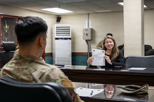 Jordan Jacobs, American Red Cross regional program manager and 51st Logistics Readiness Squadron key support liaison, discusses the LRS contact sheet at Osan Air Base, Republic of Korea, March 26, 2026. Jacobs was recently recognized as the 51st Fighter Wing and Seventh Air Force Key Support Liaison of the Year and was nominated for Pacific Air Forces due to her impact reaching far beyond programs and events. (U.S. Air Force photo by Staff Sgt. Tylir Meyer)