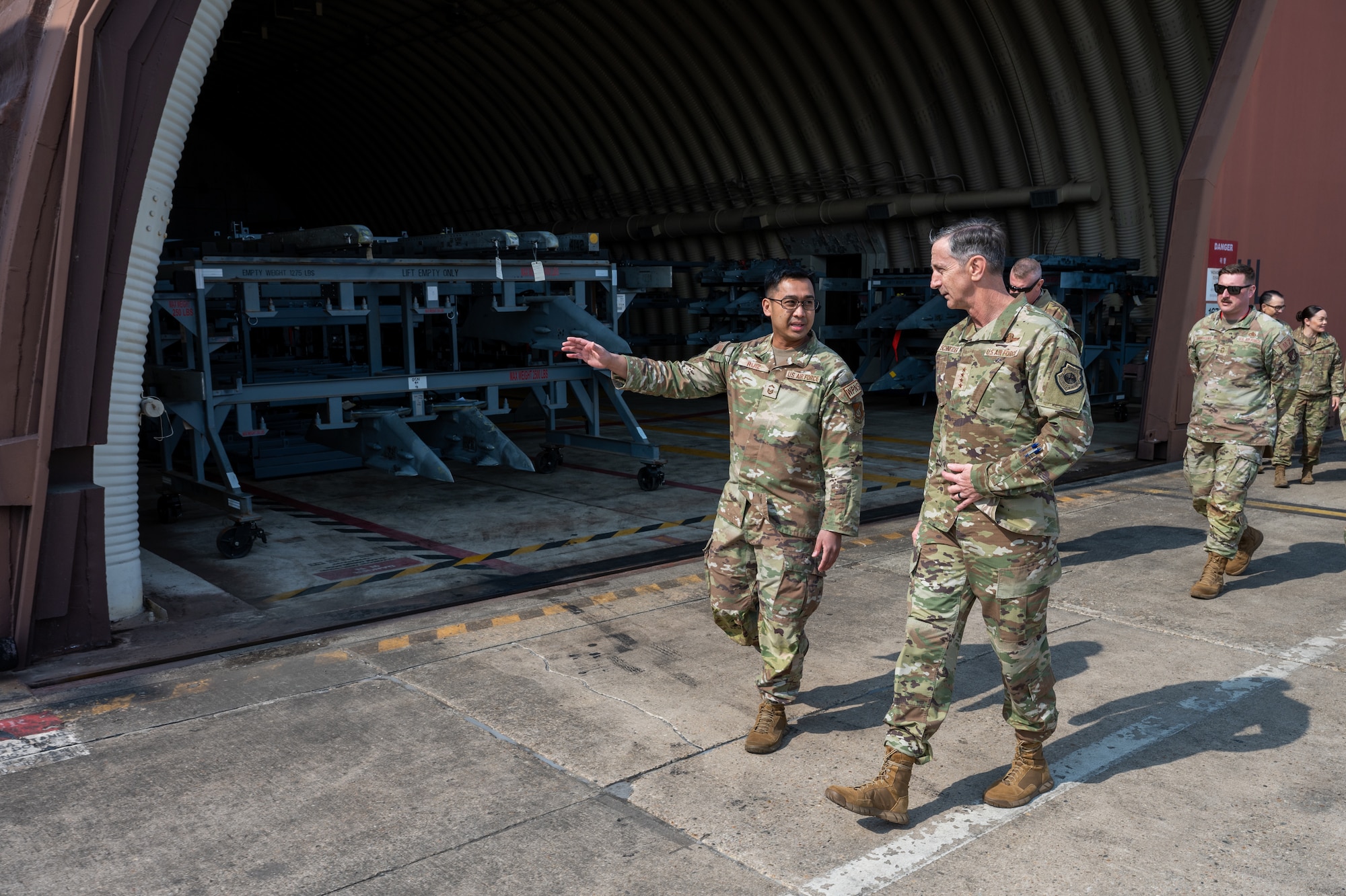 A munitions Airman briefs the PACAF commander during a tour.