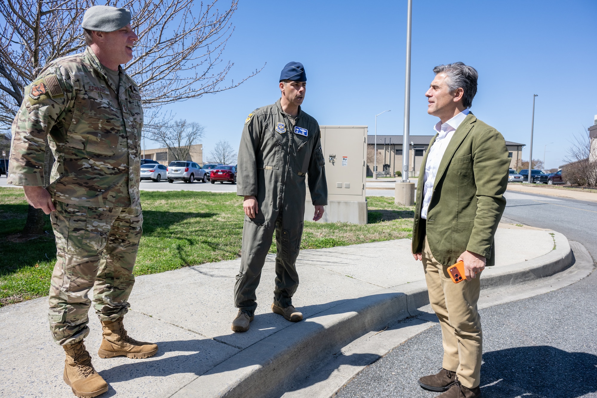 U.S. Air Force Col. Jamil Musa, center, 436th Airlift Wing commander, and Chief Master Sgt. Elijah Edwards, left, 436th AW command chief, welcomes Chris Buccini to Dover Air Force Base, Delaware, March 24, 2026. Buccini was one of 35 new members inducted into the honorary commander program at Dover AFB. (U.S. Air Force photo by Mauricio Campino)