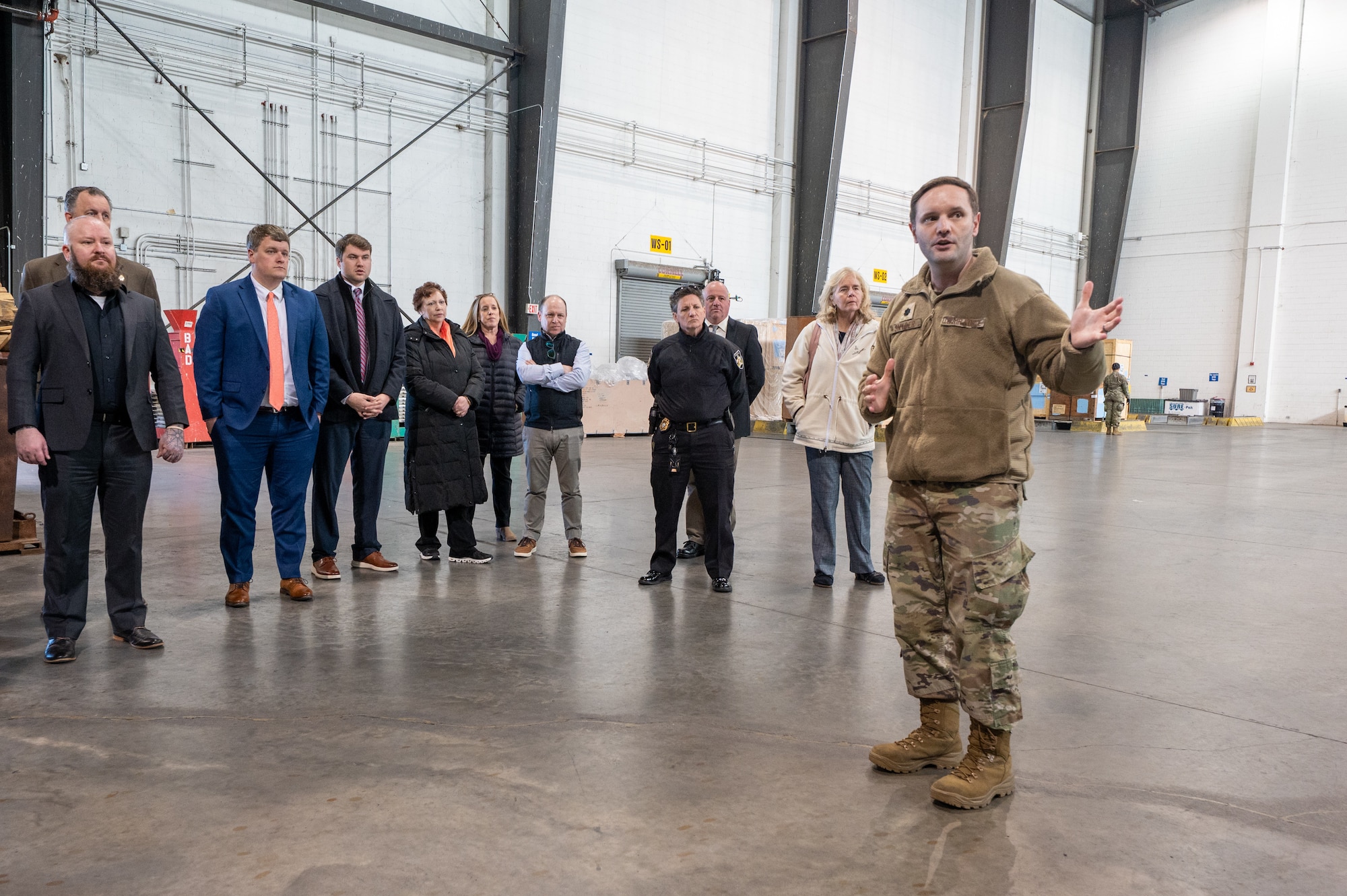 U.S. Air Force Lt. Col. Kurtis Snyder Jr., 436th Aerial Port Squadron commander, leads Class of 2026 honorary commander inductees during a tour of the aerial port facility on Dover Air Force Base, Delaware, March 24, 2026. Established in 1992, the Dover AFB HCC program is a community outreach effort that builds upon the great relationships between local civic leaders and Dover AFB personnel. (U.S. Air Force photo by Mauricio Campino)