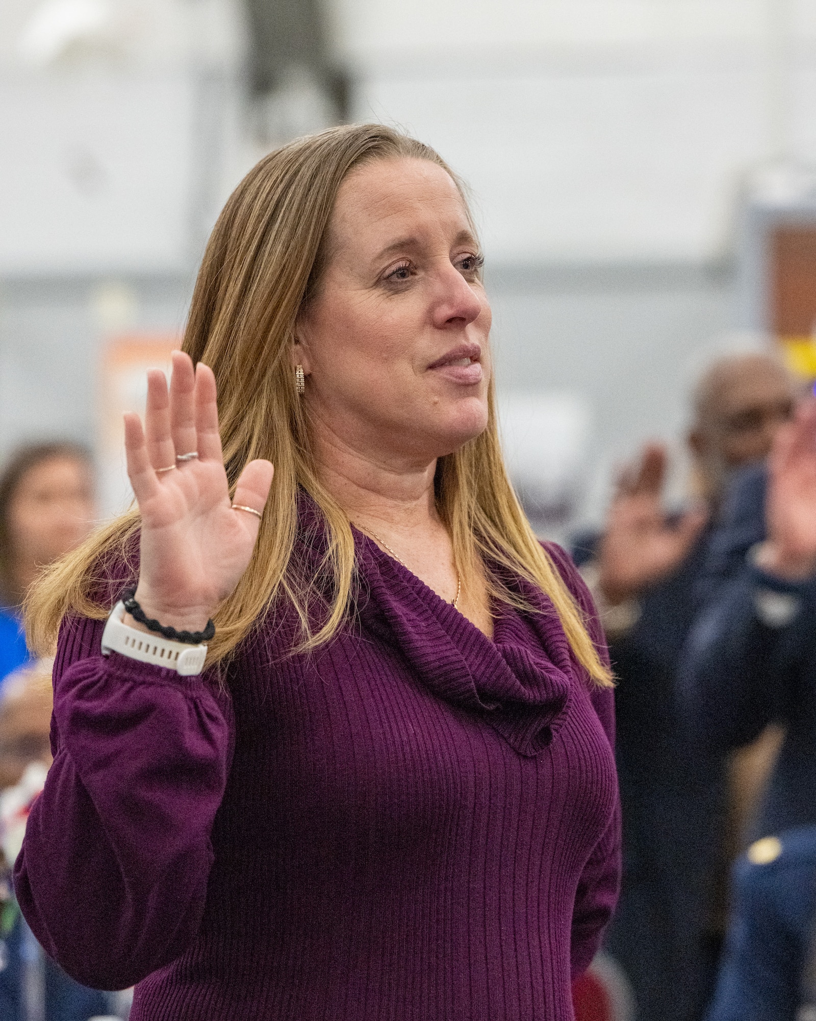 Amy Zook, Chesapeake Utilities Sourcing Associate, recites the Honorary Commander oath during the Class of 2026 HCC Induction Ceremony at the Air Mobility Command Museum, Dover Air Force Base, Delaware, March 24, 2026. Zook was inducted into the HCC program as an honorary commander for the 512th Airlift Wing command chief, Chief Master Sgt. Leonard Werner III. (U.S. Air Force photo by Mauricio Campino)