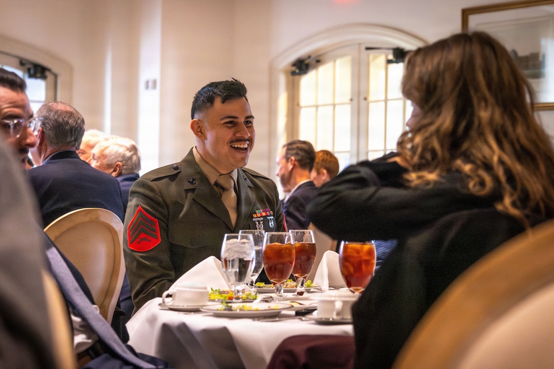 U.S. Marine Corps Sgt. Isaac A. Parada, an administrative clerk, Headquarters Battalion, Marine Forces Reserve, converses during the annual military appreciation day luncheon hosted by the New Orleans Navy League at the Metairie Country Club, Metairie, Louisiana, March 18, 2026. The New Orleans Navy League hosted the event to recognize and award service members in the New Orleans area. (U.S. Marine Corps photo by Lance Cpl. Edward Spears)