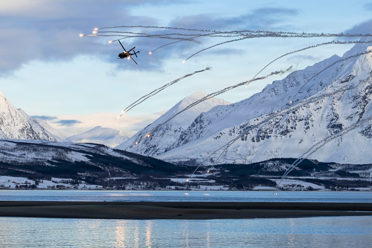 A U.S. Air Force HH-60W Jolly Green II releases flares during combat search and rescue training with Swedish air force rangers as part of Cold Response in Norway, March 13, 2026. The exercise was designed to strengthen rapid response capabilities and resilient sustainment in the high north, reinforcing NATO's collective defense. (U.S. Air Force photo by Staff Sgt. Brooke Rogers)