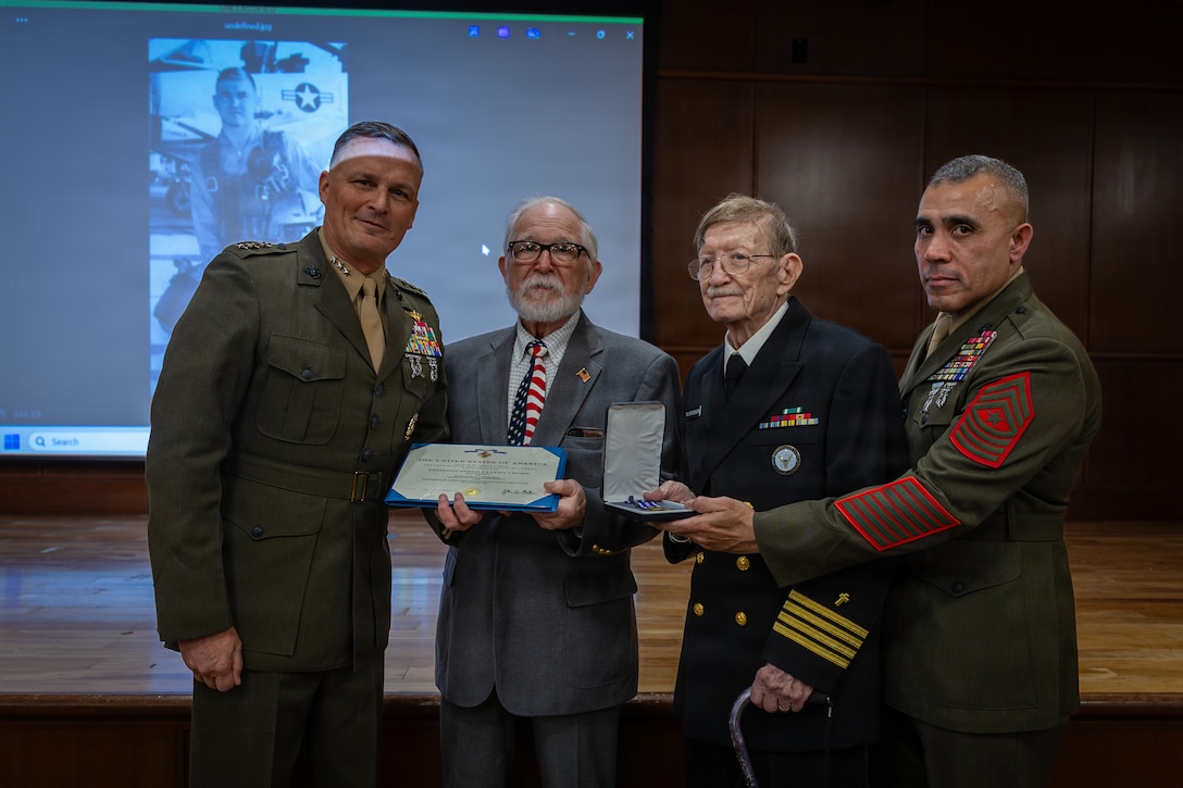 Allan and Raymond McPherson, center, brothers of the late Maj. Everette McPherson, pose for a photo with Lt. Gen. Leonard F. Anderson IV, left, commander of Marine Forces Reserve and Marine Forces South, and Sgt. Maj. Edwin A. Mota, right, senior enlisted leader of Marine Forces Reserve and Marine Forces South, during a posthumous Distinguished Flying Cross ceremony honoring the heroic actions of their brother at Marine Support Facility New Orleans, March 18, 2026. The Distinguished Flying Cross is awarded to those who have displayed single acts of heroism or extraordinary achievement while participating in aerial flight. Maj. McPherson, a fighter jet pilot, posthumously received the award for sacrificing his life during the Vietnam War in an attempt to save the life of his co-pilot.  (U.S. Marine Corps photo by Lance Cpl. Claire Cheney)