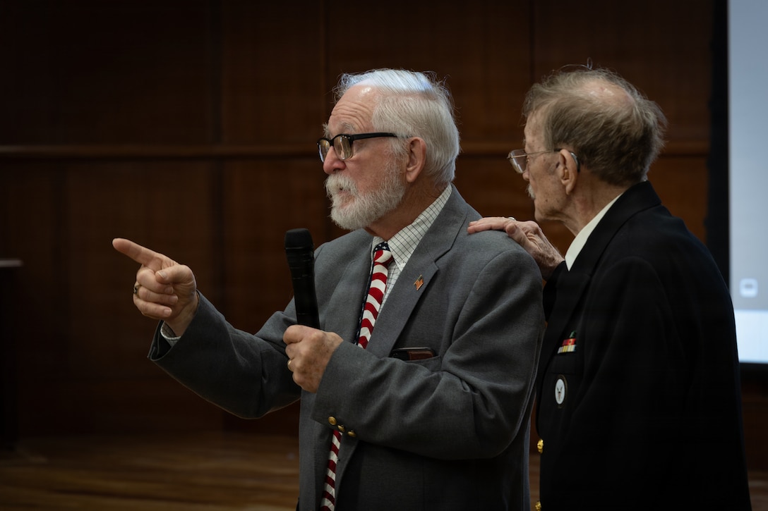 Allan McPherson, left, brother of the late Maj. Everette McPherson, speaks alongside his brother, Raymond McPherson, right, during a posthumous Distinguished Flying Cross ceremony honoring the heroic actions of their brother at Marine Support Facility New Orleans, March 18, 2026. The Distinguished Flying Cross is awarded to those who have displayed single acts of heroism or extraordinary achievement while participating in aerial flight. Maj. McPherson, a fighter jet pilot, posthumously received the award for sacrificing his life during the Vietnam War in an attempt to save the life of his co-pilot. (U.S. Marine Corps photo by Lance Cpl. Claire Cheney)