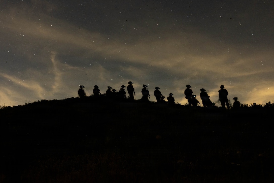 U.S. Marines assigned to Battalion Landing Team 2/4, 13th Marine Expeditionary Unit, move tactically during a simulated night raid at Raid Leaders Course 26-1, Marine Corps Base Camp Pendleton, California, March 23, 2026. Raid Leaders Course provides relevant, realistic training in close-quarters battle and breaching to prepare Marines and Sailors for deployment with the 13th Marine Expeditionary Unit. (U.S. Marine Corps photo by Sgt. Martha Linares)