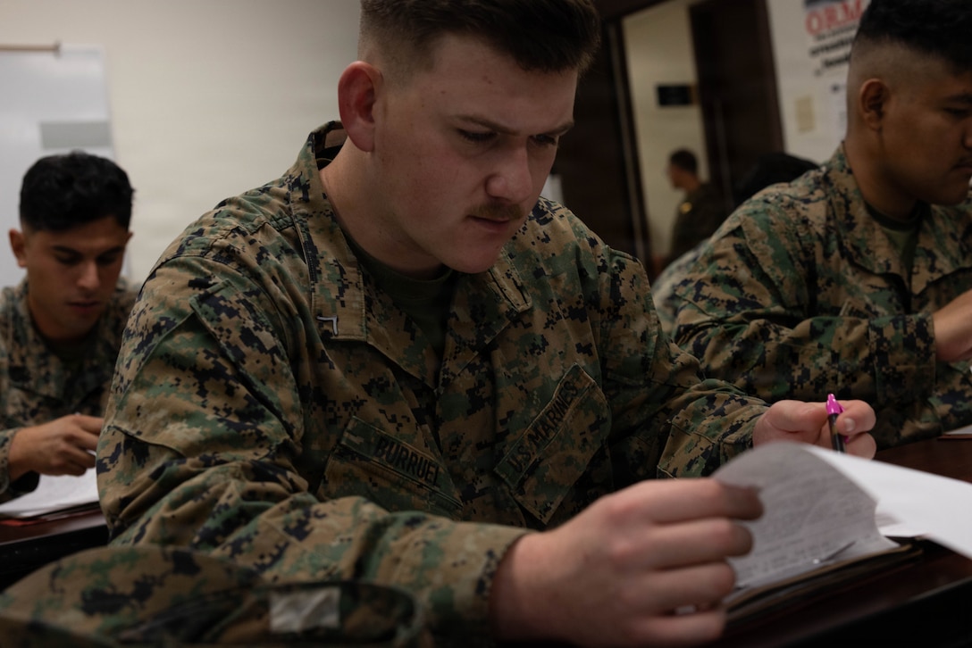 U.S. Marine Corps Lance Cpl. Burruel, a motor vehicle operator with 4th Medical Battalion, 4th Marine Logistics Group, Marine Forces Reserve, reads through his audit package during a Reserve Mobilization Exercise 26 (RMX-26), San Diego, March 3, 2026. The week-long exercise validates the battalion’s ability to rapidly activate personnel and equipment, ensuring the unit can deliver ready forces in response to a national crisis. (U.S. Marine Corps photo by Lance Cpl. Claire Cheney)
