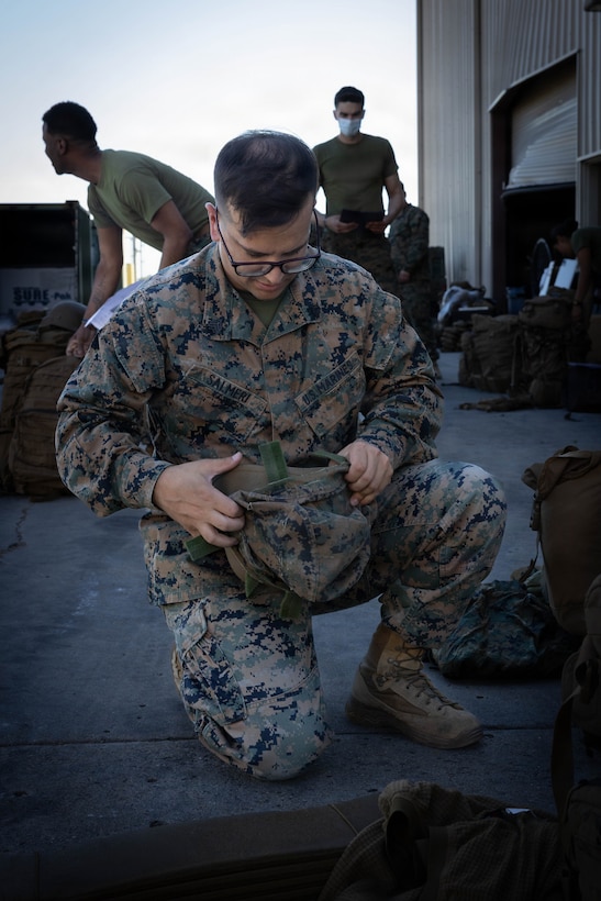 U.S. Marine Corps Sgt. Vito Salmeri, a ground electronics transmission systems maintainer with 4th Medical Battalion, 4th Marine Logistics Group, Marine Forces Reserve, puts on the camouflage covering to his kevlar during a Reserve Mobilization Exercise 26 (RMX-26), San Diego, March 3, 2026. The week-long exercise validates the battalion’s ability to rapidly activate personnel and equipment, ensuring the unit can deliver ready forces in response to a national crisis. (U.S. Marine Corps photo by Lance Cpl. Claire Cheney)