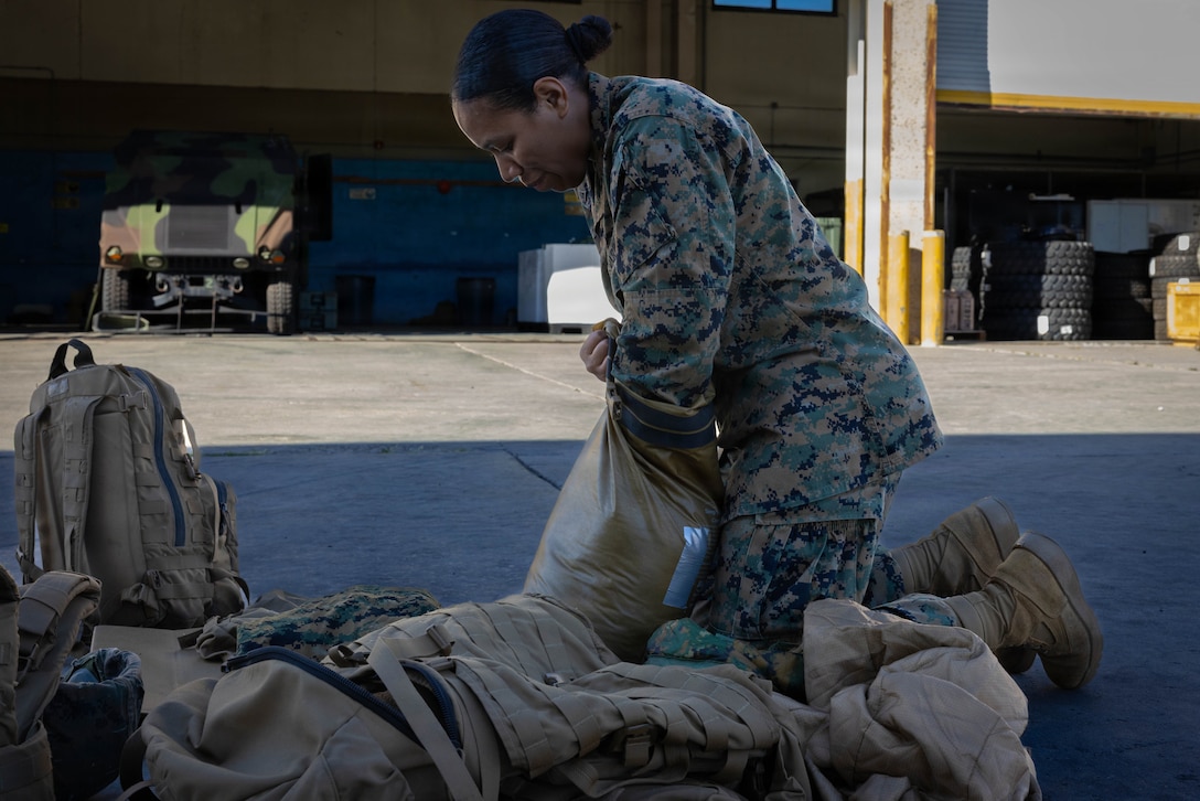 U.S. Marine Corps Lance Cpl. Angelique Skelton, a warehouse clerk with 4th Medical Battalion, 4th Marine Logistics Group, Marine Forces Reserve, prepares her gear during a Reserve Mobilization Exercise 26, San Diego, March 3, 2026. The week-long exercise validates the battalion’s ability to rapidly activate personnel and equipment, ensuring the unit can deliver ready forces in response to a national crisis. (U.S. Marine Corps photo by Lance Cpl. Claire Cheney)