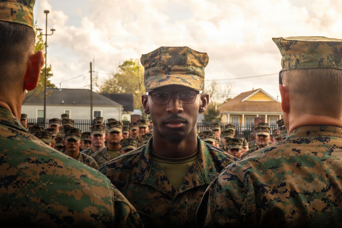 U.S. Marine Corps Sgt. Kenneth Johnson, center, a legal clerk with Headquarters Battalion, Marine Forces Reserve, stands at the position of attention at Marine Corps Support Facility New Orleans, March 10, 2026. Johnson was meritoriously promoted to the rank of sergeant by Sgt. Maj. Carlos A. Ruiz, the 20th Sergeant Major of the Marine Corps, left, and Maj. Gen. Douglas Clark, right, deputy commander of Marine Forces Reserve and Marine Corps Forces South. (U.S. Marine Corps photo by Lance Cpl. Edward Spears)